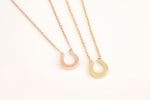 Reversed gold horseshoe necklace