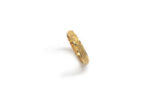 Wedding ring in solid gold with texture.