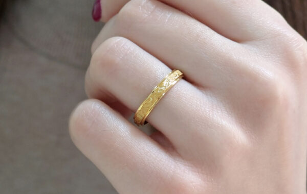 713-35 5 Wedding ring in solid gold with texture.