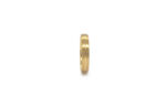 Wedding ring in solid gold with decorative lines.